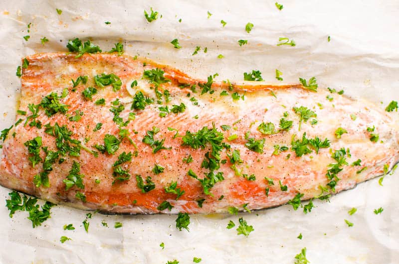 Baked salmon garnished with parsley.