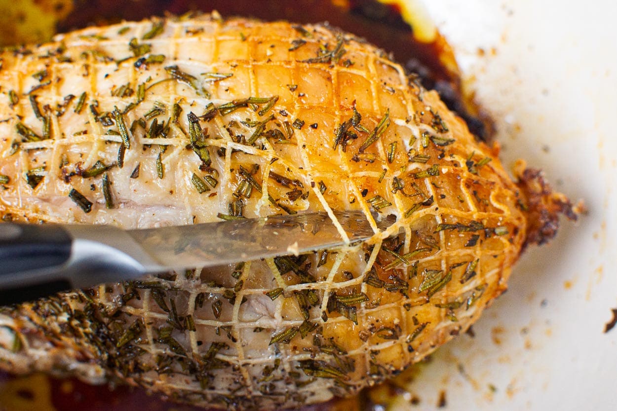 Removing turkey meat casing with sharp knife.