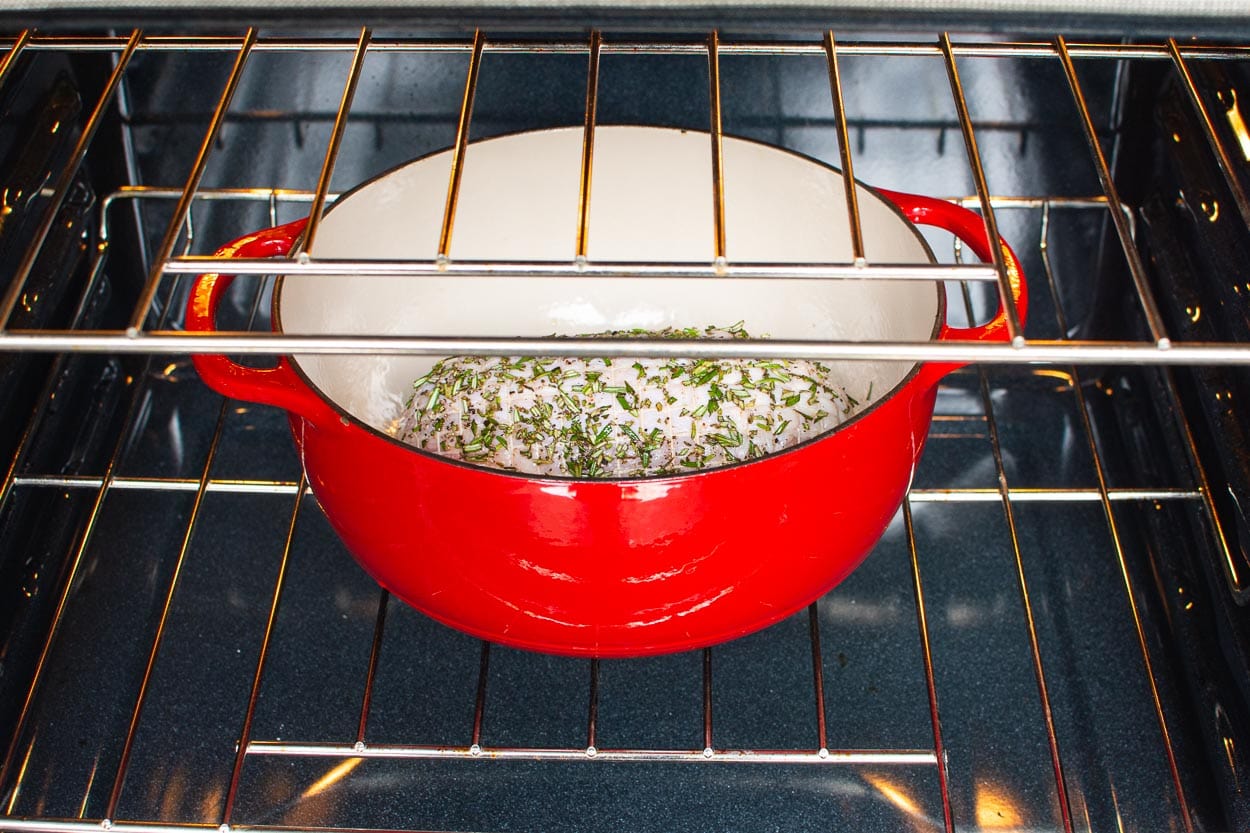 Turkey breast in a large red pot in the oven. 