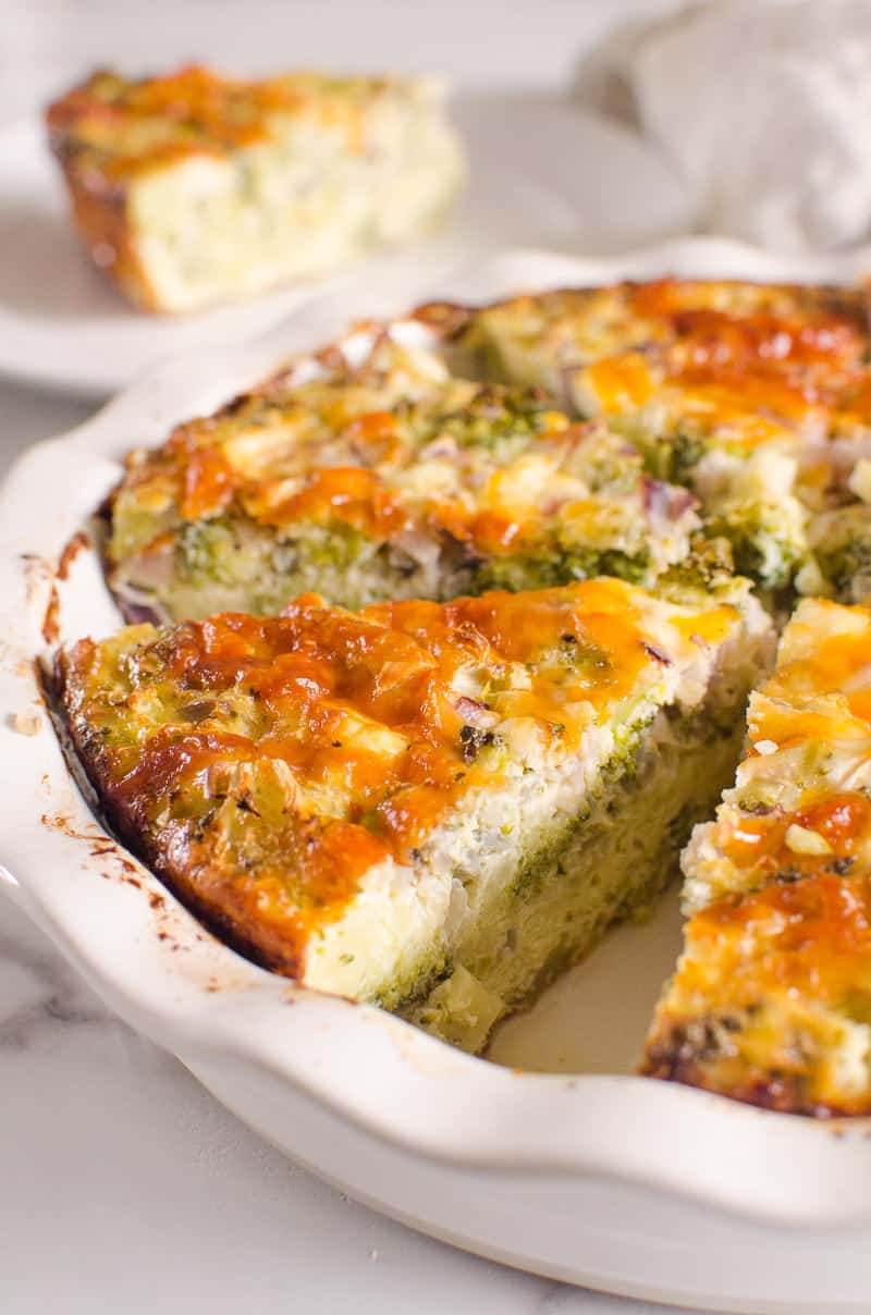 Crustless broccoli quiche sliced in a baking dish.