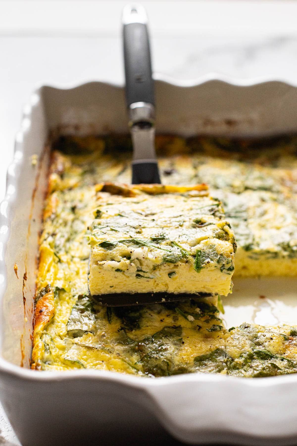 Side view of cottage cheese egg bake showing texture on a spatula.