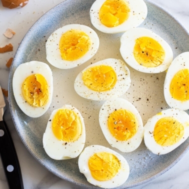 Air fryer hard boiled eggs cut in half on a plate.