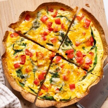 Sliced egg tortilla on a cutting board.