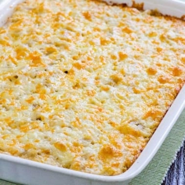 Baked cauliflower mac and cheese in white baking dish.