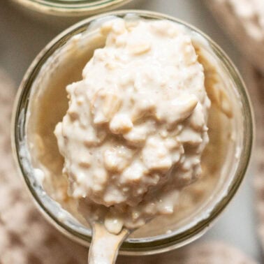 Cottage cheese overnight oats on a spoon above a jar.