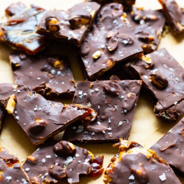 Date bark sprinkled with sea salt on parchment paper.