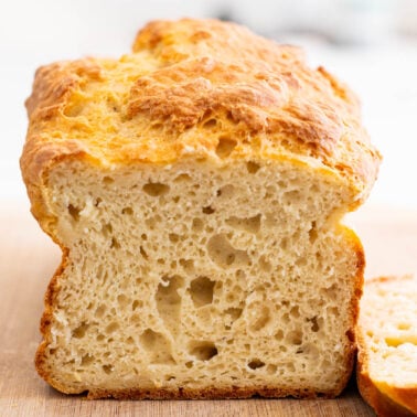 Sliced Greek yogurt bread on a cutting board.