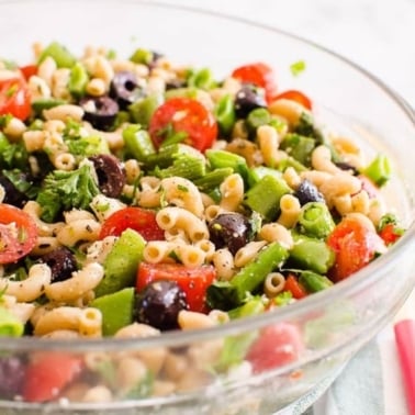 Healthy pasta salad with vegetables in a serving bowl.