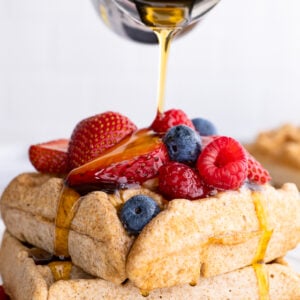 healthy waffles topped with berries and syrup