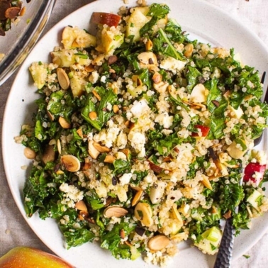 kale with quinoa apples in large bowl with fork