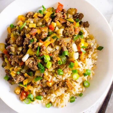 Korean ground beef and rice bowls garnished with green onion.