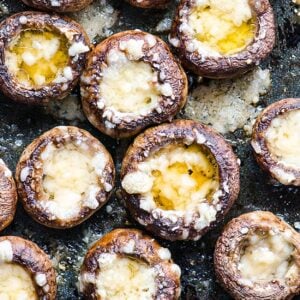 Baked mushroom caps filled with melted parmesan cheese.