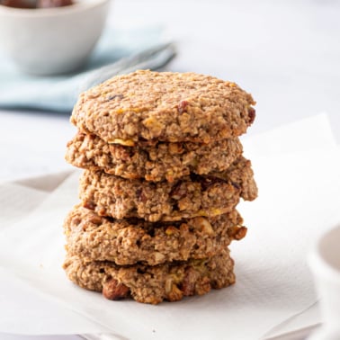 Five sugar free oatmeal cookies stacked on a counter.
