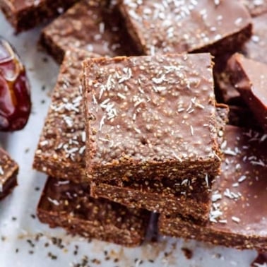 A stack of superfood chocolate bars on white plate.