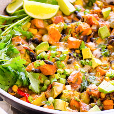 Tex Mex sweet potato skillet garnished with fresh cilantro, avocado and green onion.