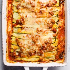 Zucchini lasagna in white baking dish.