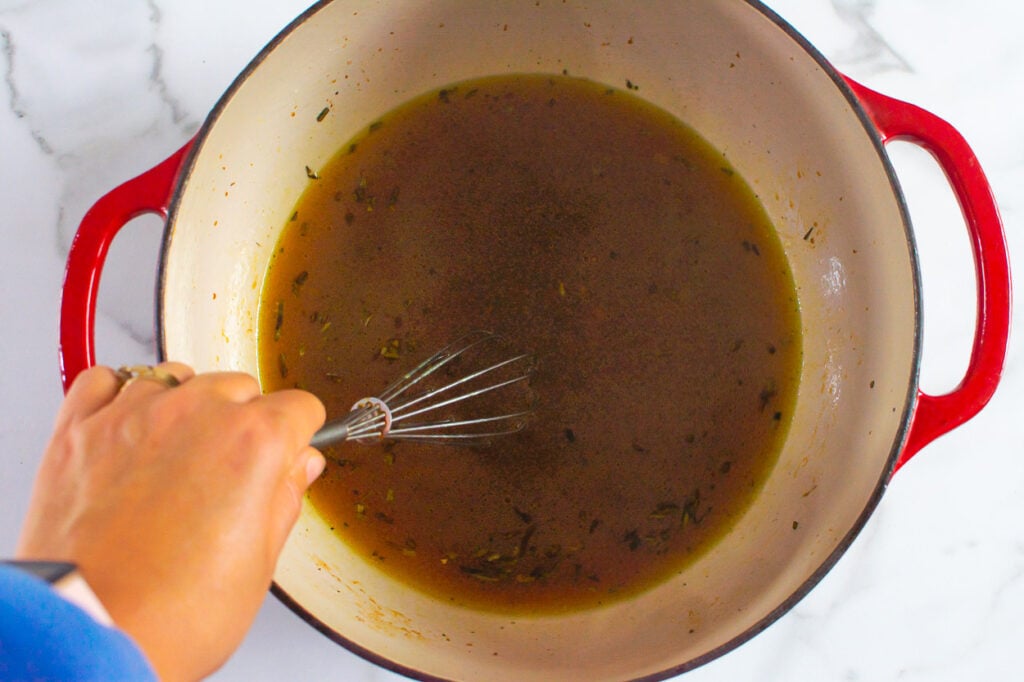 whisking healthy turkey gravy in a pot