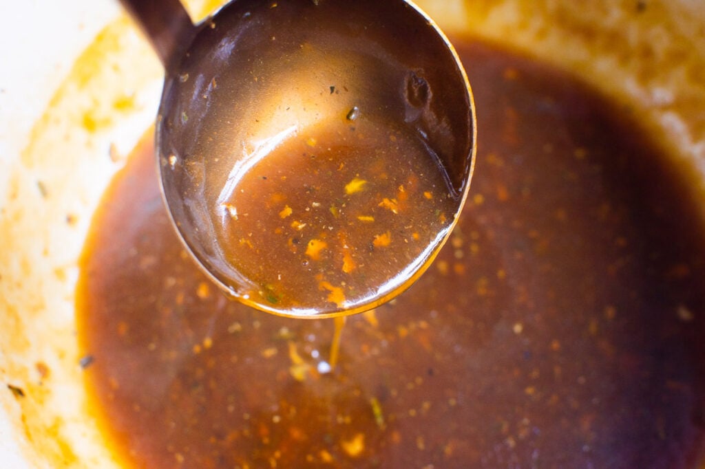 healthy turkey gravy in a ladle over pot