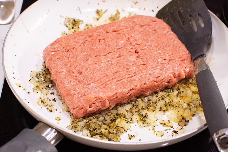 Cooking ground turkey in skillet with onion and dried spices.