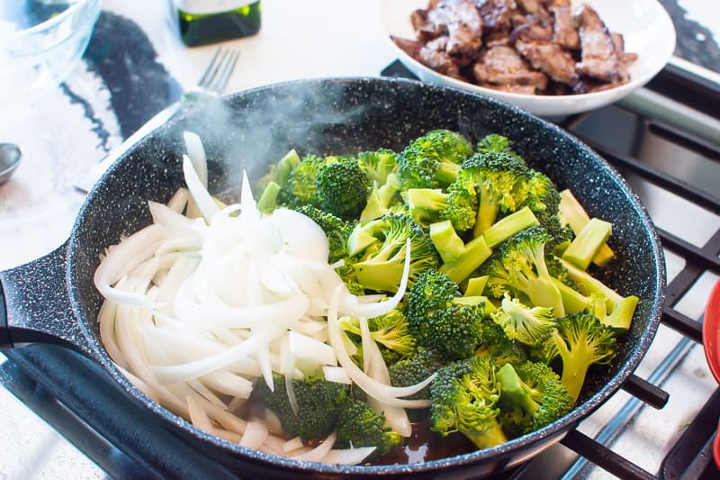 Broccoli and onion in skillet. 