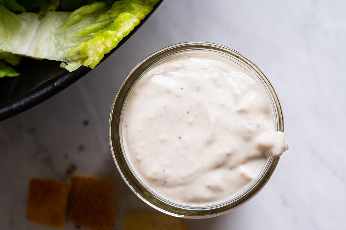 Healthy caesar dressing in a glass mason jar.