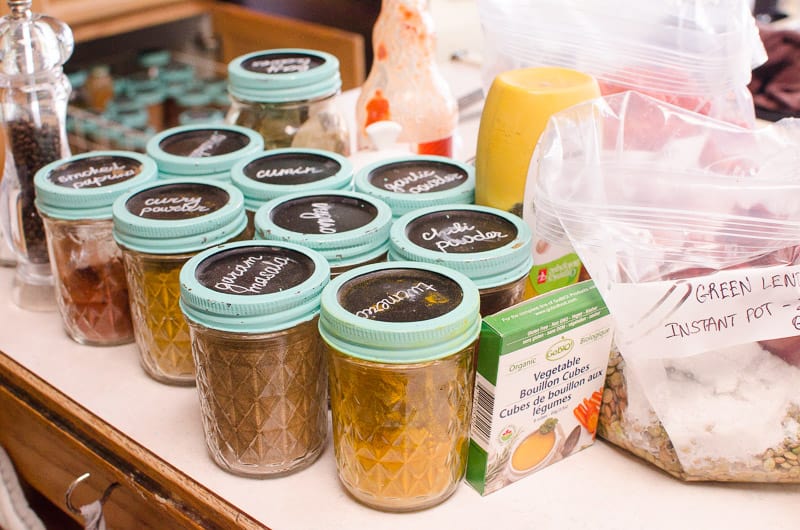 Spices, stock and seasonings on a kitchen countertop.