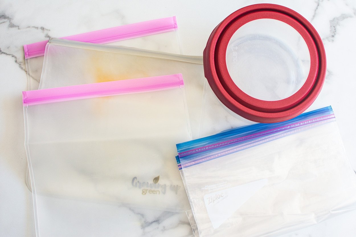 Plastic bags and glass container on a counter.