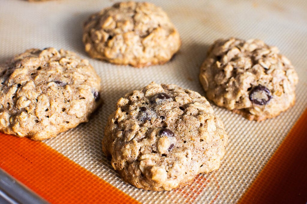 Baked oatmeal cookies on a baking sheet.