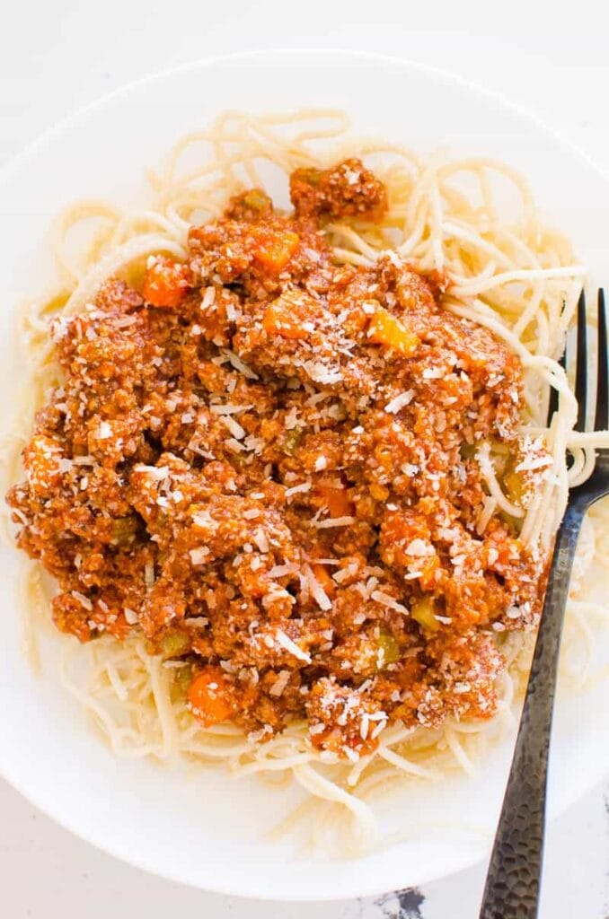 Spaghetti noodles with meat sauce and parmesan.
