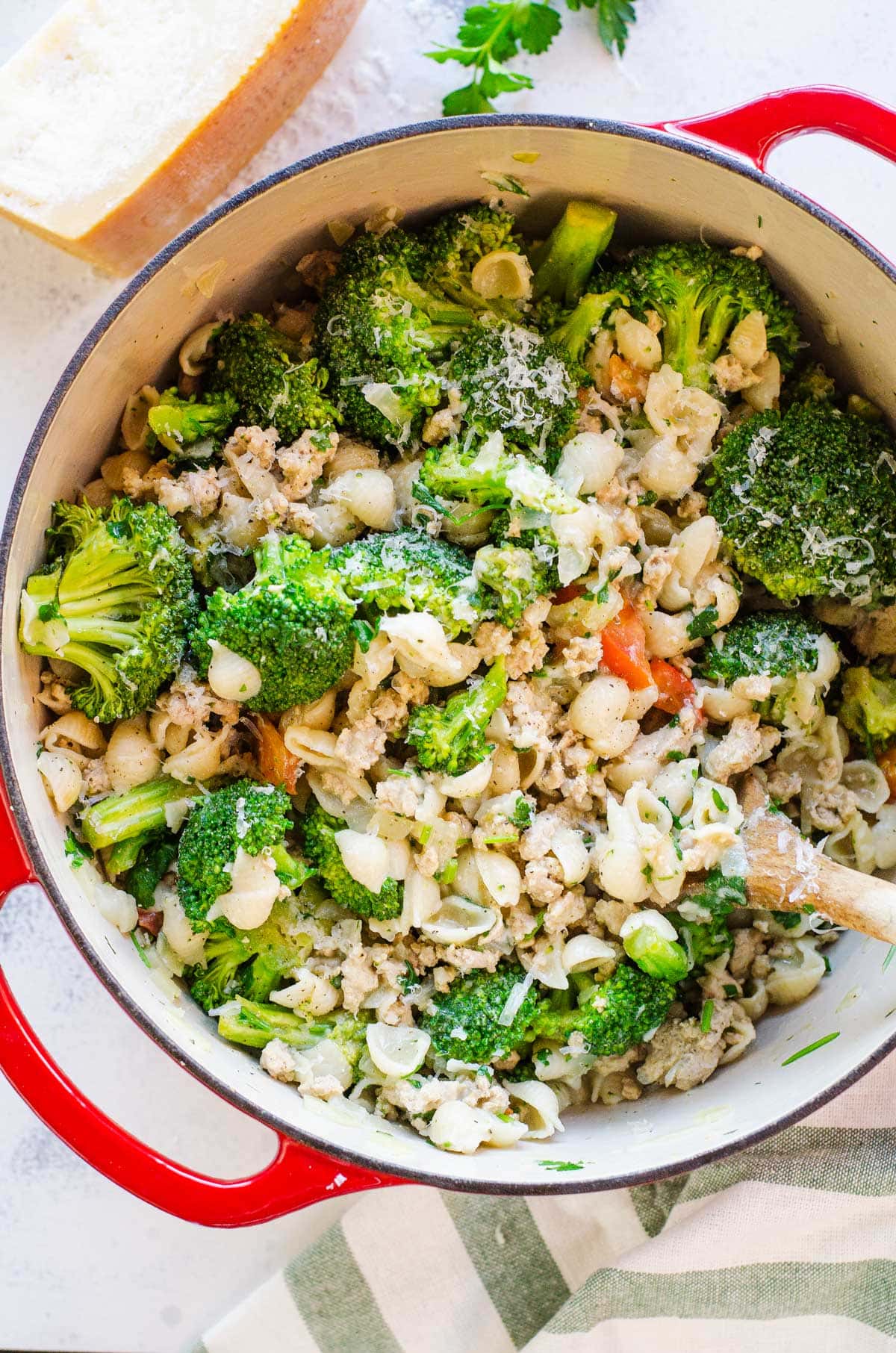 Small pasta shells with broccoli in red pot. 