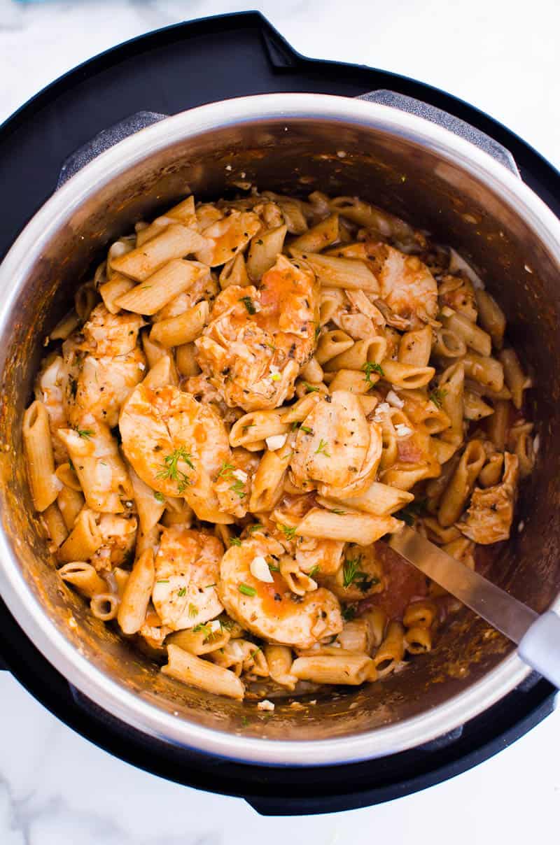 Penne pasta with chicken and sauce inside Instant Pot. 