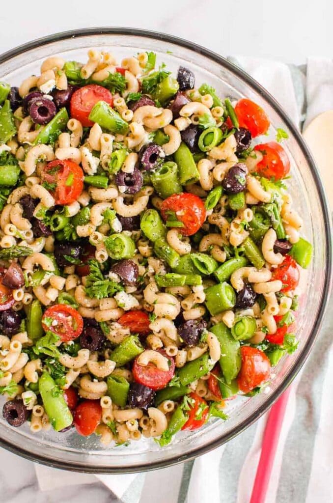 Macaroni noodles with green beans, olives, and cherry tomatoes. 