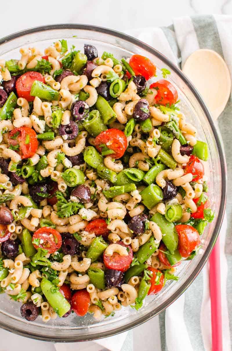 Healthy pasta salad in glass bowl.