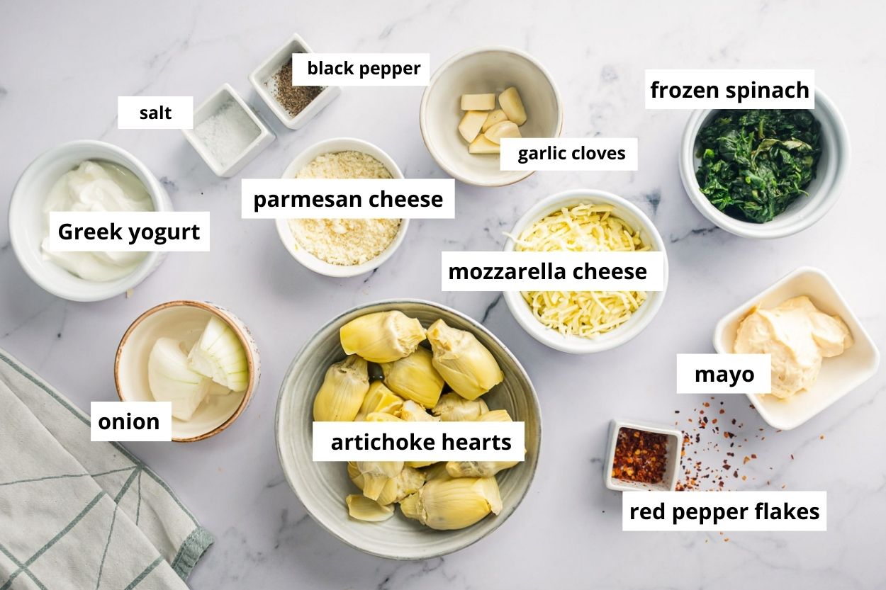 Artichoke hearts, frozen spinach, mayo, Parmesan cheese, mozzarella cheese, Greek yogurt, garlic, red pepper flakes, onion, salt, pepper.