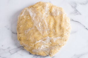 wrapping sugar cookie dough with almond flour for chilling