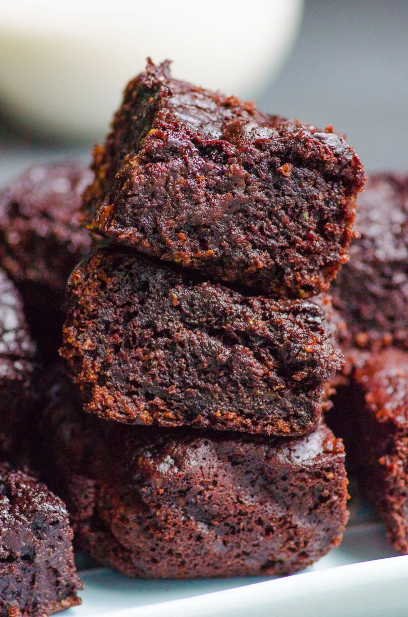 Three healthy zucchini brownies stacked on top of each other.