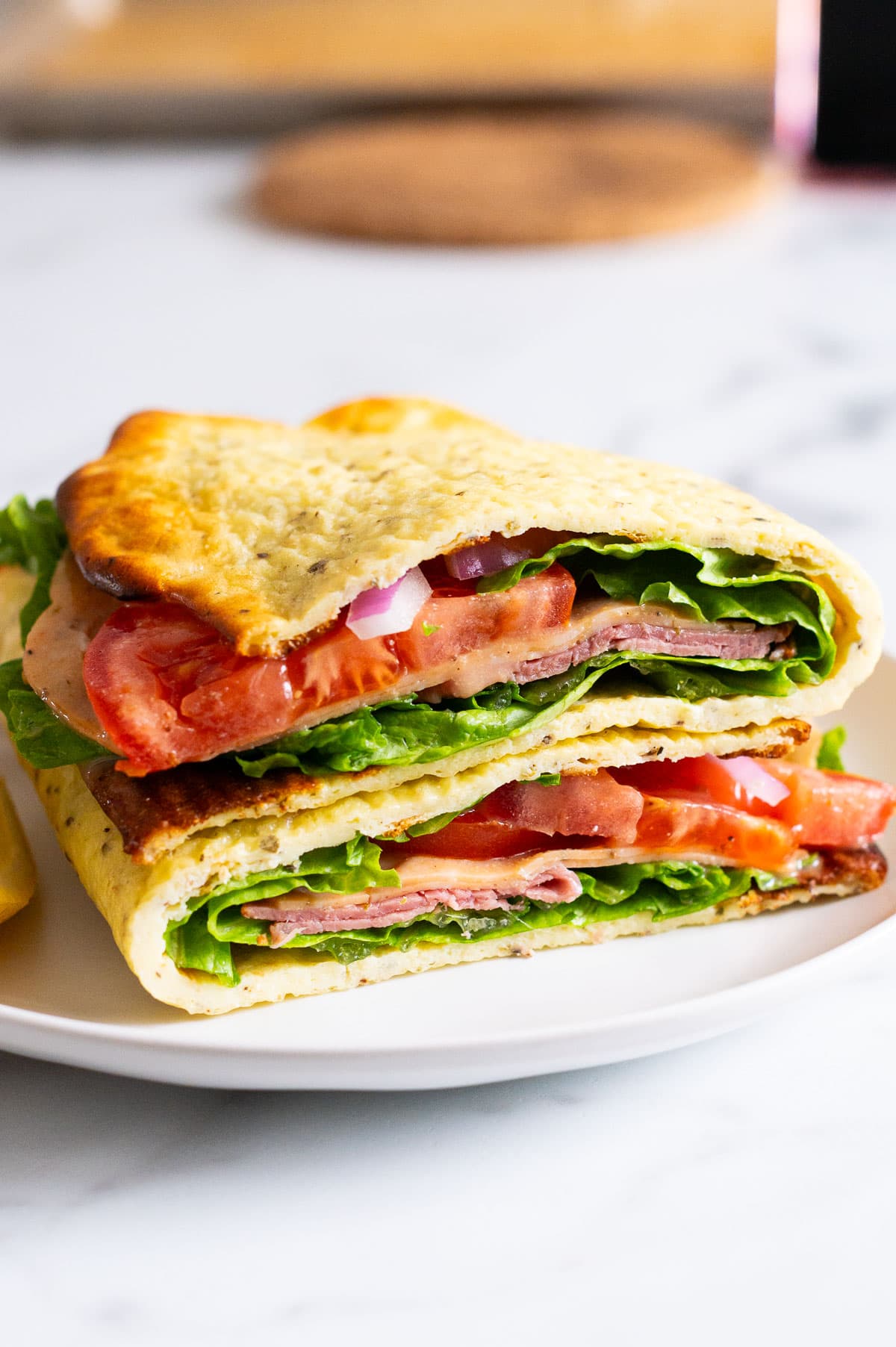 High protein sandwich cut in half and served on a plate.