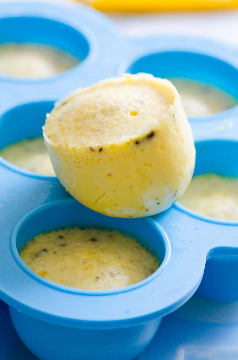 One egg bite sitting on top of a mold of cooked Instant Pot egg bites.