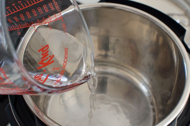 Adding water to Instant Pot.