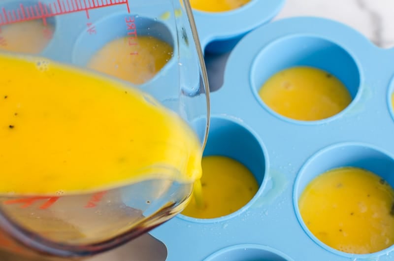 Pouring egg mixture into egg bite mold.
