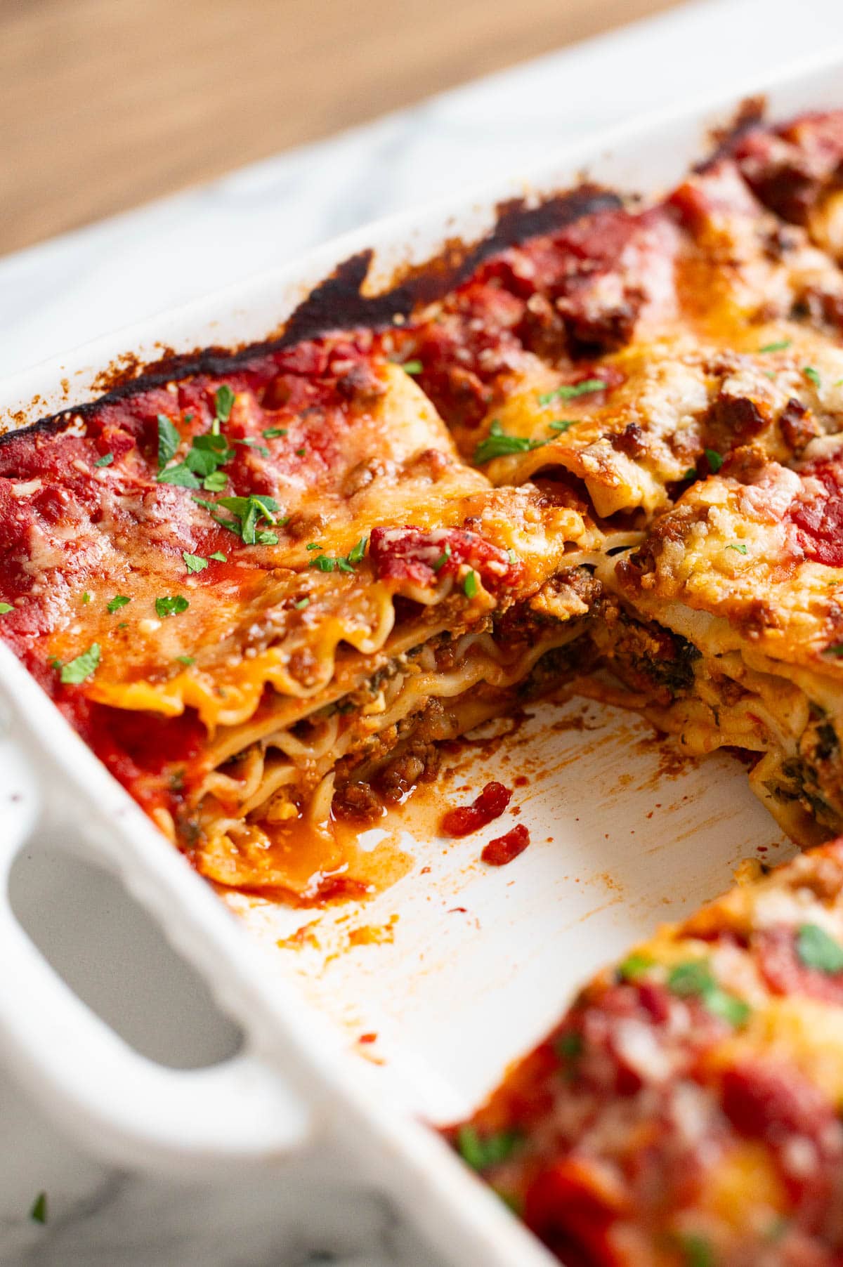 Cottage cheese lasagna in a baking dish showing texture inside.