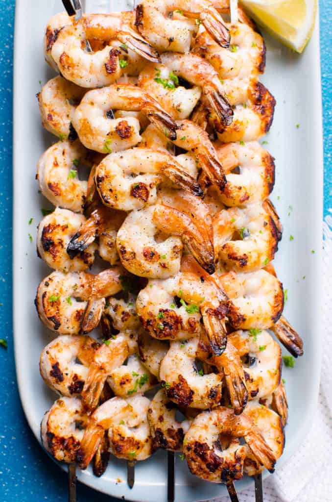 Shrimp skewers on white plate. 