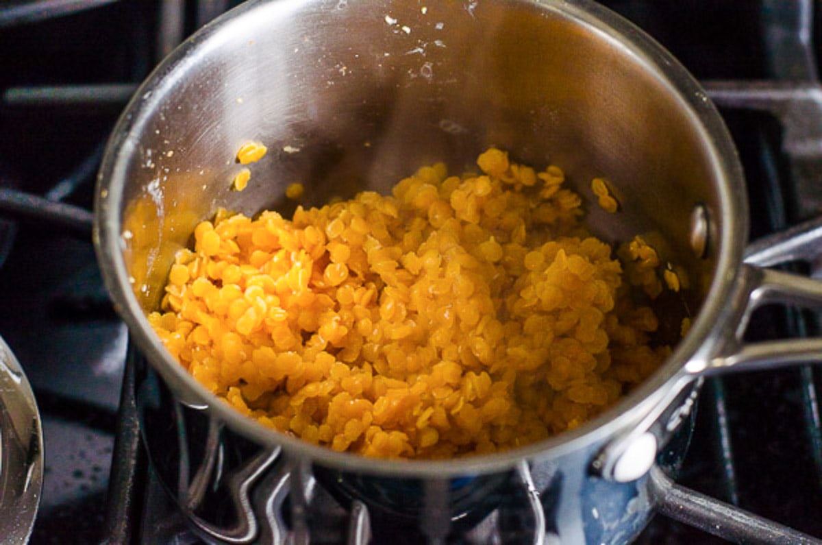 Cooked red lentils in a pot.