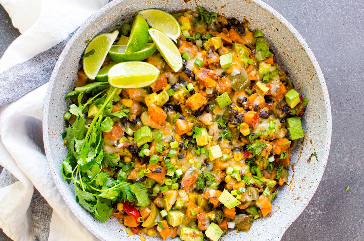 Tex Mex sweet potato skillet with black beans, corn, avocado, cilantro and lime.